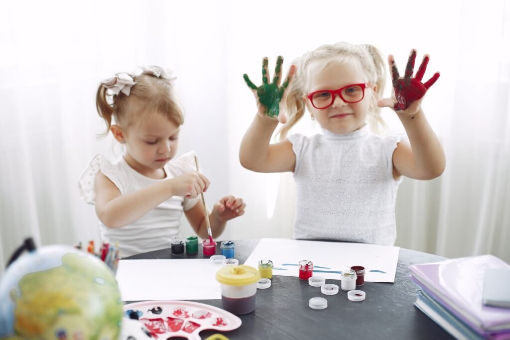 Children exploring paint at kindergarten