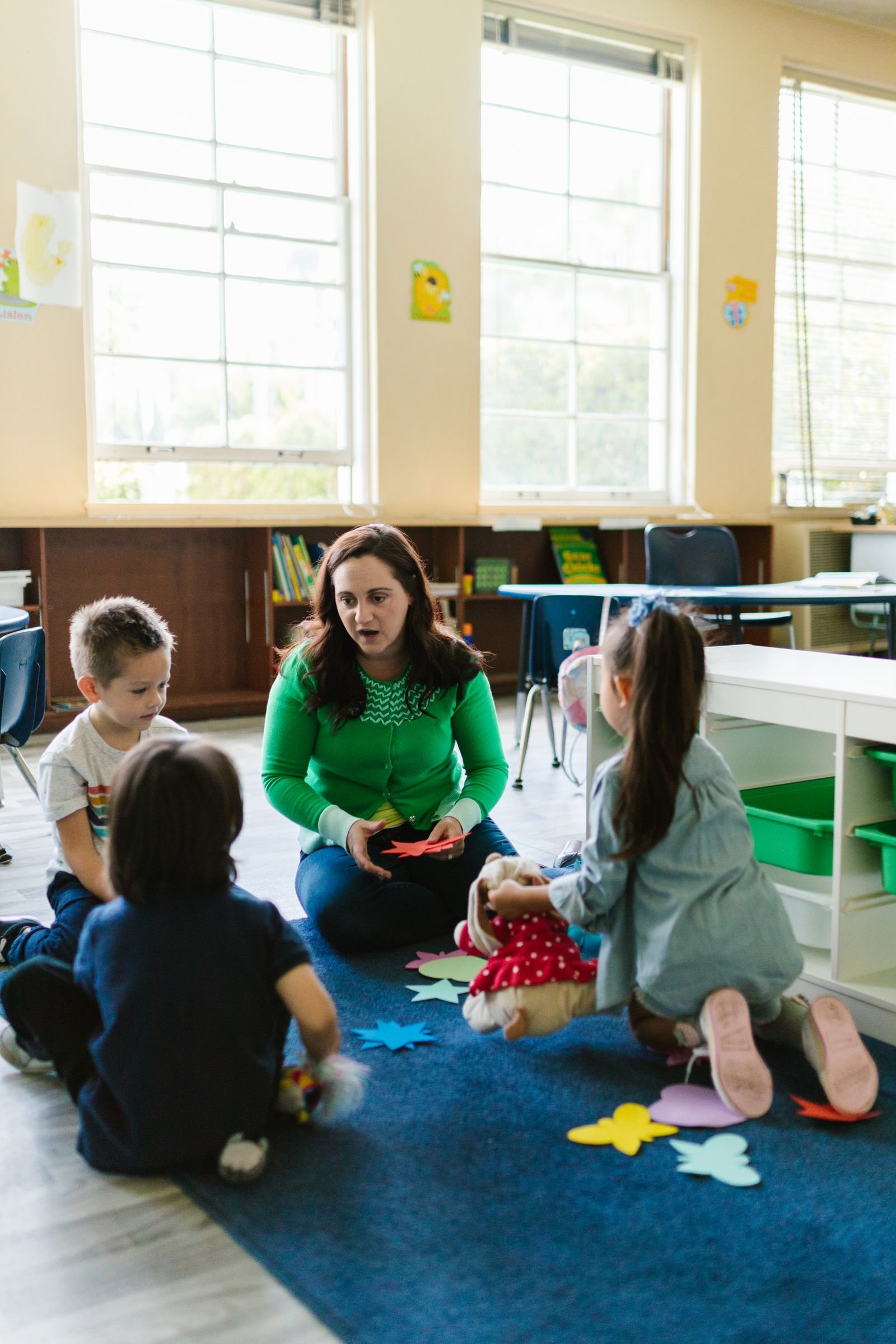 Teacher talking with young children in a classroom