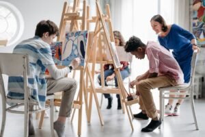 Children painting together in an art class